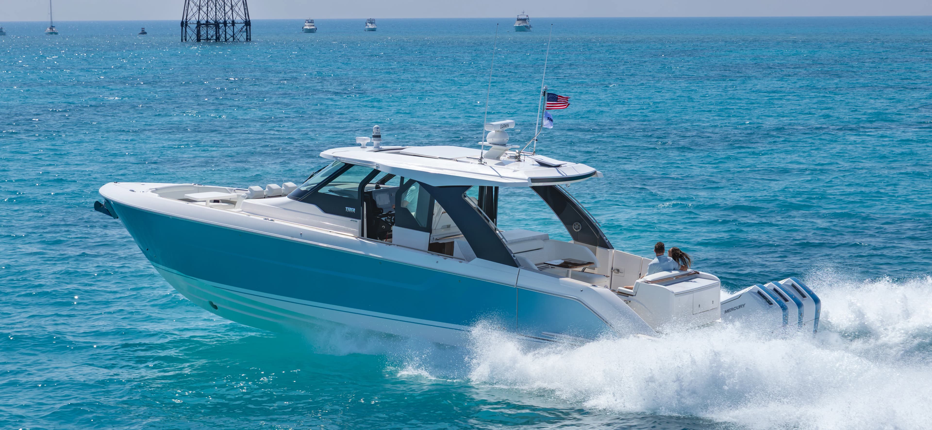 46 LS Running to port, couple sits in aft lounge, 46 foot luxury boat, Tiara 46, 46 foot boat